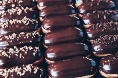 Traditional french eclairs with chocolate. Tasty dessert. Home made cake eclairs Sweet. Dessert. Pastry filled with cream. Chocolate icing.