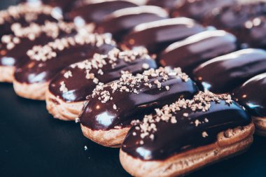 Traditional french eclairs with chocolate. Tasty dessert. Home made cake eclairs Sweet. Dessert. Pastry filled with cream. Chocolate icing.