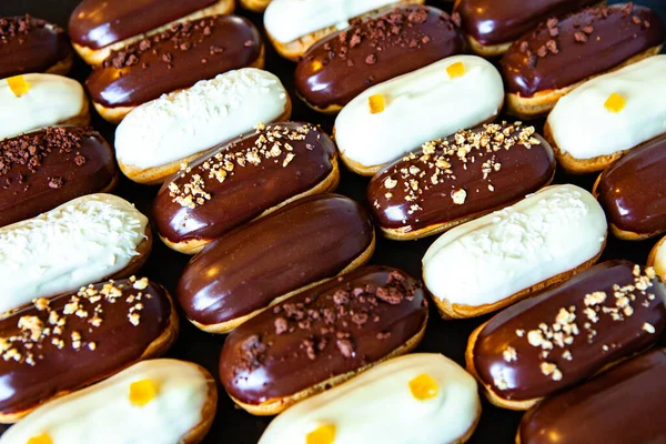 Traditional french eclairs with chocolate. Tasty dessert. Home made cake eclairs Sweet. Dessert. Pastry filled with cream. Chocolate icing.