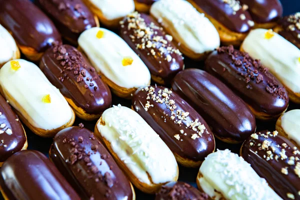 Traditional french eclairs with chocolate. Tasty dessert. Home made cake eclairs Sweet. Dessert. Pastry filled with cream. Chocolate icing.