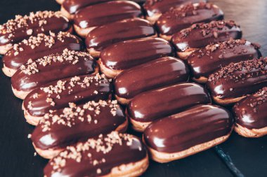 Traditional french eclairs with chocolate. Tasty dessert. Home made cake eclairs Sweet. Dessert. Pastry filled with cream. Chocolate icing.