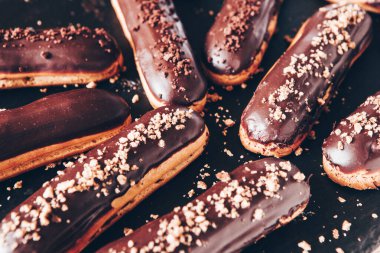 Traditional french eclairs with chocolate. Tasty dessert. Home made cake eclairs Sweet. Dessert. Pastry filled with cream. Chocolate icing.