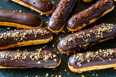Traditional french eclairs with chocolate. Tasty dessert. Home made cake eclairs Sweet. Dessert. Pastry filled with cream. Chocolate icing.