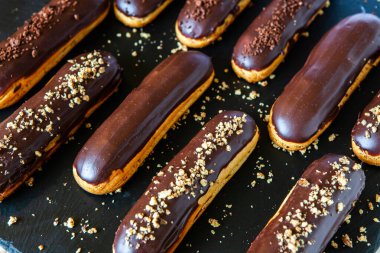 Traditional french eclairs with chocolate. Tasty dessert. Home made cake eclairs Sweet. Dessert. Pastry filled with cream. Chocolate icing.
