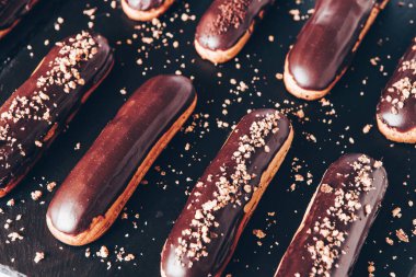Traditional french eclairs with chocolate. Tasty dessert. Home made cake eclairs Sweet. Dessert. Pastry filled with cream. Chocolate icing.