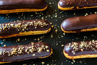 Traditional french eclairs with chocolate. Tasty dessert. Home made cake eclairs Sweet. Dessert. Pastry filled with cream. Chocolate icing.