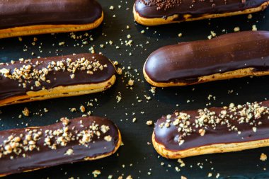 Traditional french eclairs with chocolate. Tasty dessert. Home made cake eclairs Sweet. Dessert. Pastry filled with cream. Chocolate icing.