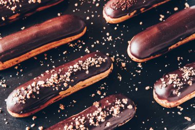 Traditional french eclairs with chocolate. Tasty dessert. Home made cake eclairs Sweet. Dessert. Pastry filled with cream. Chocolate icing.