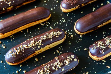 Traditional french eclairs with chocolate. Tasty dessert. Home made cake eclairs Sweet. Dessert. Pastry filled with cream. Chocolate icing.