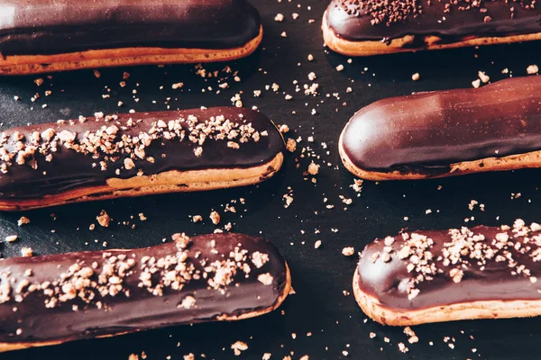 Traditional french eclairs with chocolate. Tasty dessert. Home made cake eclairs Sweet. Dessert. Pastry filled with cream. Chocolate icing.
