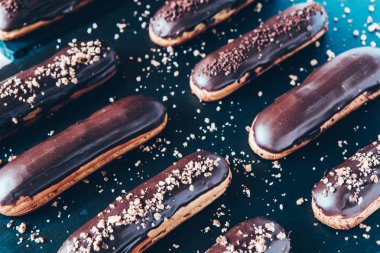 Traditional french eclairs with chocolate. Tasty dessert. Home made cake eclairs Sweet. Dessert. Pastry filled with cream. Chocolate icing.