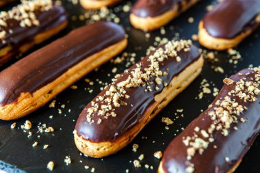 Traditional french eclairs with chocolate. Tasty dessert. Home made cake eclairs Sweet. Dessert. Pastry filled with cream. Chocolate icing.