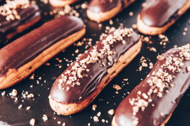Traditional french eclairs with chocolate. Tasty dessert. Home made cake eclairs Sweet. Dessert. Pastry filled with cream. Chocolate icing.