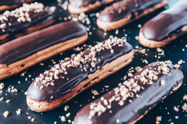 Traditional french eclairs with chocolate. Tasty dessert. Home made cake eclairs Sweet. Dessert. Pastry filled with cream. Chocolate icing.