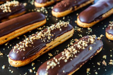 Traditional french eclairs with chocolate. Tasty dessert. Home made cake eclairs Sweet. Dessert. Pastry filled with cream. Chocolate icing.