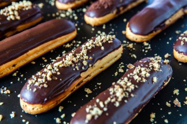 Traditional french eclairs with chocolate. Tasty dessert. Home made cake eclairs Sweet. Dessert. Pastry filled with cream. Chocolate icing.