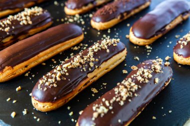 Traditional french eclairs with chocolate. Tasty dessert. Home made cake eclairs Sweet. Dessert. Pastry filled with cream. Chocolate icing.