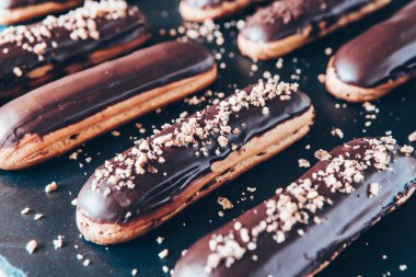 Traditional french eclairs with chocolate. Tasty dessert. Home made cake eclairs Sweet. Dessert. Pastry filled with cream. Chocolate icing.