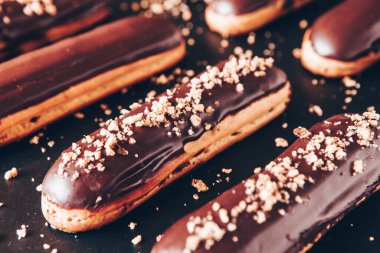 Traditional french eclairs with chocolate. Tasty dessert. Home made cake eclairs Sweet. Dessert. Pastry filled with cream. Chocolate icing.
