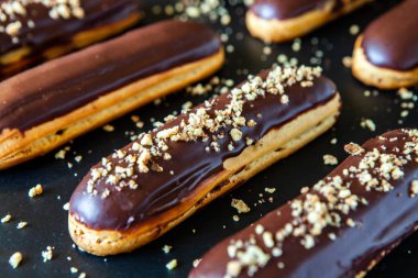Traditional french eclairs with chocolate. Tasty dessert. Home made cake eclairs Sweet. Dessert. Pastry filled with cream. Chocolate icing.
