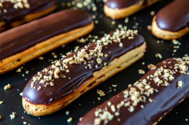 Traditional french eclairs with chocolate. Tasty dessert. Home made cake eclairs Sweet. Dessert. Pastry filled with cream. Chocolate icing.