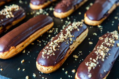 Traditional french eclairs with chocolate. Tasty dessert. Home made cake eclairs Sweet. Dessert. Pastry filled with cream. Chocolate icing.