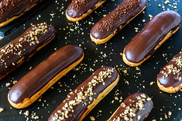 Traditional french eclairs with chocolate. Tasty dessert. Home made cake eclairs Sweet. Dessert. Pastry filled with cream. Chocolate icing.