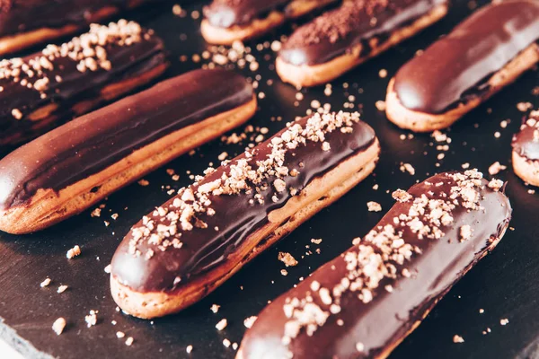 Traditional french eclairs with chocolate. Tasty dessert. Home made cake eclairs Sweet. Dessert. Pastry filled with cream. Chocolate icing.