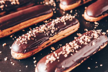 Traditional french eclairs with chocolate. Tasty dessert. Home made cake eclairs Sweet. Dessert. Pastry filled with cream. Chocolate icing.