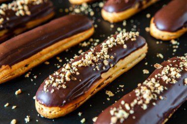Traditional french eclairs with chocolate. Tasty dessert. Home made cake eclairs Sweet. Dessert. Pastry filled with cream. Chocolate icing.
