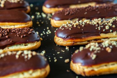 Traditional french eclairs with chocolate. Tasty dessert. Home made cake eclairs Sweet. Dessert. Pastry filled with cream. Chocolate icing.