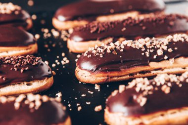 Traditional french eclairs with chocolate. Tasty dessert. Home made cake eclairs Sweet. Dessert. Pastry filled with cream. Chocolate icing.