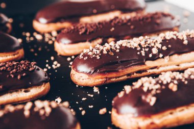 Traditional french eclairs with chocolate. Tasty dessert. Home made cake eclairs Sweet. Dessert. Pastry filled with cream. Chocolate icing.