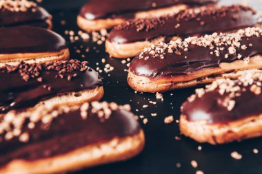 Traditional french eclairs with chocolate. Tasty dessert. Home made cake eclairs Sweet. Dessert. Pastry filled with cream. Chocolate icing.