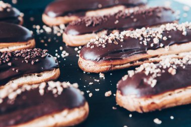Traditional french eclairs with chocolate. Tasty dessert. Home made cake eclairs Sweet. Dessert. Pastry filled with cream. Chocolate icing.