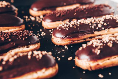 Traditional french eclairs with chocolate. Tasty dessert. Home made cake eclairs Sweet. Dessert. Pastry filled with cream. Chocolate icing.