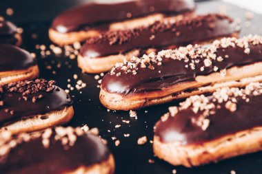 Traditional french eclairs with chocolate. Tasty dessert. Home made cake eclairs Sweet. Dessert. Pastry filled with cream. Chocolate icing.