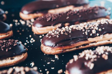 Traditional french eclairs with chocolate. Tasty dessert. Home made cake eclairs Sweet. Dessert. Pastry filled with cream. Chocolate icing.