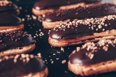 Traditional french eclairs with chocolate. Tasty dessert. Home made cake eclairs Sweet. Dessert. Pastry filled with cream. Chocolate icing.