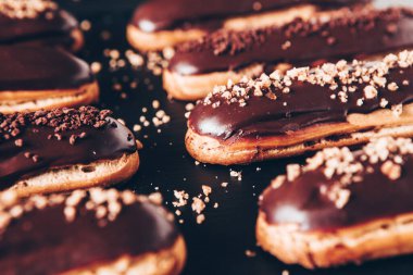 Traditional french eclairs with chocolate. Tasty dessert. Home made cake eclairs Sweet. Dessert. Pastry filled with cream. Chocolate icing.
