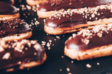 Traditional french eclairs with chocolate. Tasty dessert. Home made cake eclairs Sweet. Dessert. Pastry filled with cream. Chocolate icing.