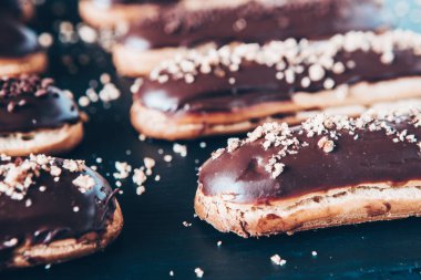 Traditional french eclairs with chocolate. Tasty dessert. Home made cake eclairs Sweet. Dessert. Pastry filled with cream. Chocolate icing.