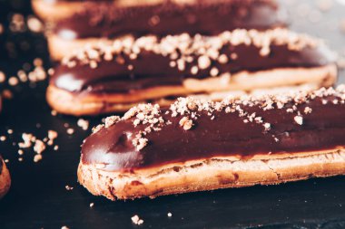 Traditional french eclairs with chocolate. Tasty dessert. Home made cake eclairs Sweet. Dessert. Pastry filled with cream. Chocolate icing.