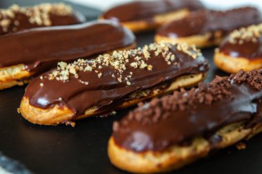 Traditional french eclairs with chocolate. Tasty dessert. Home made cake eclairs Sweet. Dessert. Pastry filled with cream. Chocolate icing.