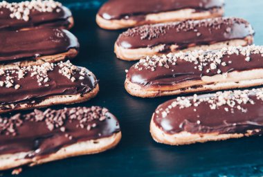 Traditional french eclairs with chocolate. Tasty dessert. Home made cake eclairs Sweet. Dessert. Pastry filled with cream. Chocolate icing.