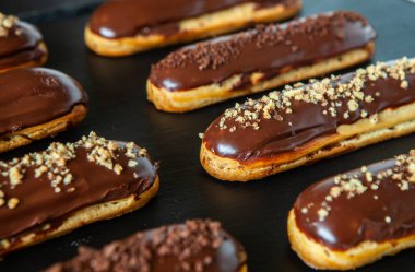 Traditional french eclairs with chocolate. Tasty dessert. Home made cake eclairs Sweet. Dessert. Pastry filled with cream. Chocolate icing.