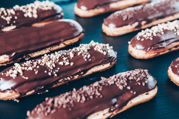 Traditional french eclairs with chocolate. Tasty dessert. Home made cake eclairs Sweet. Dessert. Pastry filled with cream. Chocolate icing.