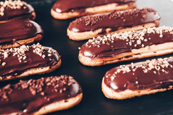Traditional french eclairs with chocolate. Tasty dessert. Home made cake eclairs Sweet. Dessert. Pastry filled with cream. Chocolate icing.
