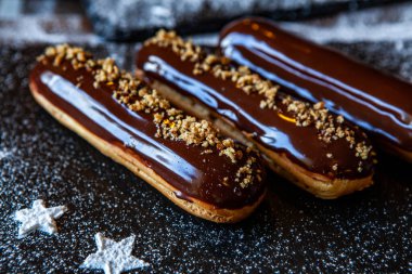 Traditional french eclairs with chocolate. Tasty dessert. Home made cake eclairs Sweet. Dessert. Pastry filled with cream. Chocolate icing.