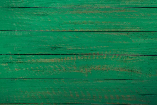 Vintage green wood background texture with knots and nail holes. Old painted wood wall. Brown abstract background. Vintage green wooden dark horizontal boards. Front view with copy space. Background for design.